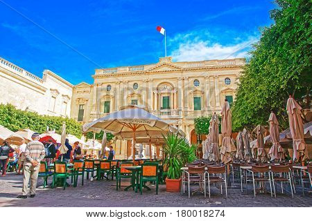 People Resting At Open Air Cafes Of Republic Square Valletta