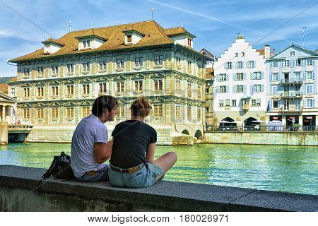 Zurich Switzerland - September 2 2016: People relaxing at Old Town Hall in Limmat River embankment in Zurich Switzerland