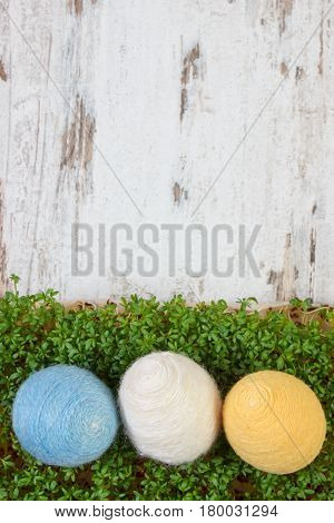 Easter Eggs Wrapped Woolen String And Green Cress On Wooden Background, Copy Space For Text, Decorat