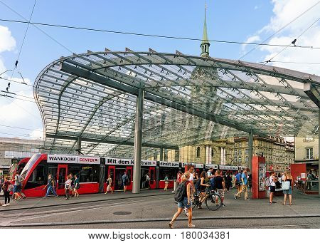 Tram And People At Train Station On Bahnhofplatz Of Bern