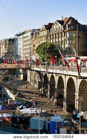 Flon District With Grand Pont Bridge With Flags In Lausanne