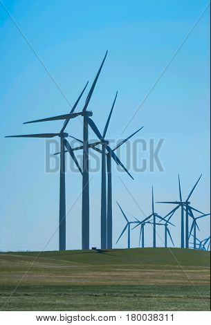 Wind turbines far off in hot sun