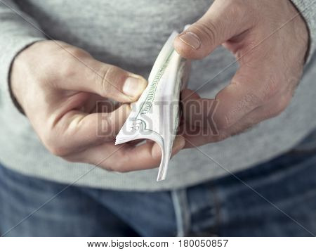 Hands counting dollars. Selective focus. Shallow DOF