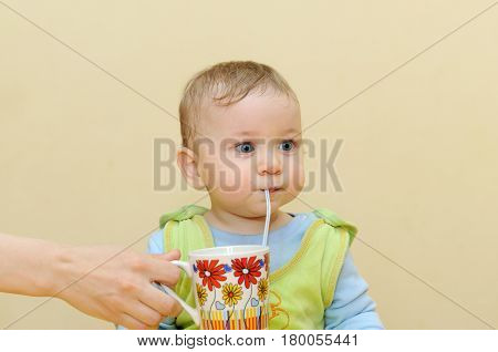 Baby Drinks Juice Through A Straw