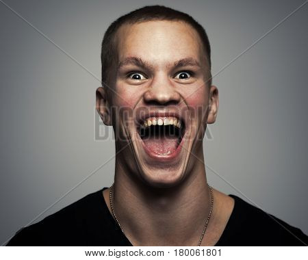 young man with a loud and scary scream. Portrait