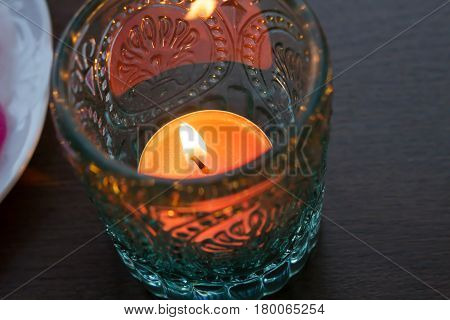 pink candle and light blue candle on a table .