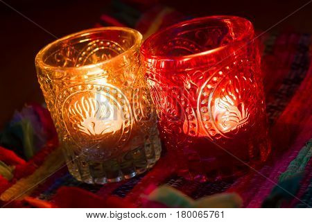 pink candle and light blue candle on a table .
