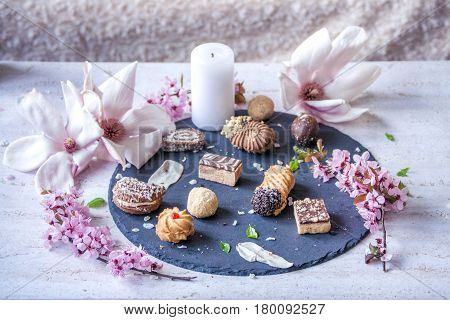 Assorted Homemade Cookies and Spring Flowers and Candle