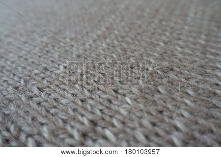 Close-up of grey handmade plain knit stitch fabric