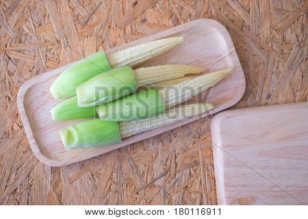 Decorative close up of mini corn on wood tray