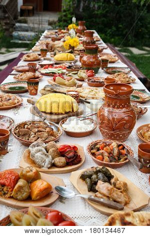 table with homemade moldavian food in clay dishes