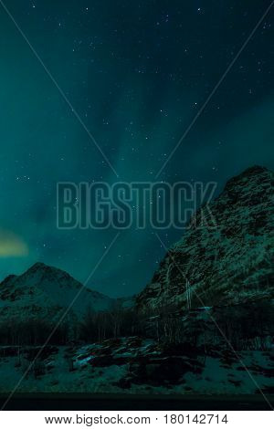 Aurora Borealis Known as Nother Lights Playing with Vivid Colors Over Lofoten Islands in Norway.Vertical Image Orientation