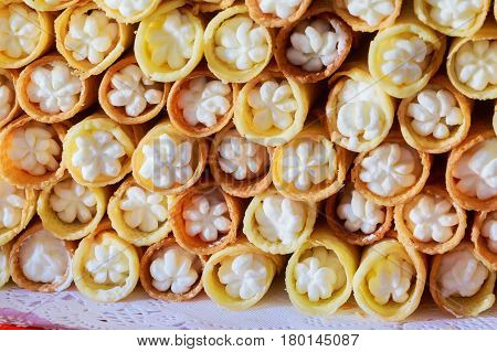 Rows of freshly baked sweet buns or bread rolls with sweet filling and sugar dust against white paper background, tasty buns like perfect food for lunch of tea time, bun as present for coffee time