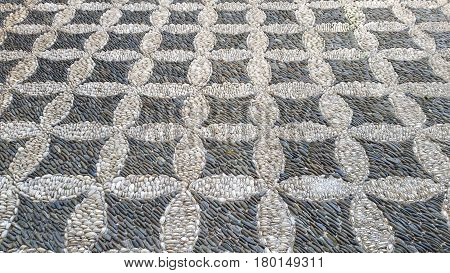 Cobbled pavement made of river rounded pebbles in Cordoba, Andalusia, Spain. Background texture. Patio Andaluz