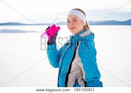 Sporty girl drinking water after workout. Healthy diet concept