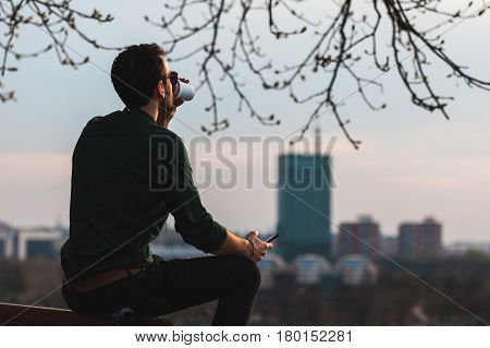 Young man enjoying his coffee break listening to the music