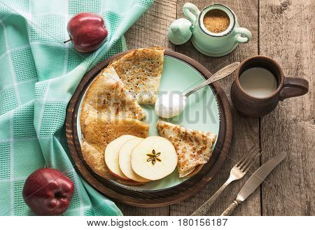 Tasty traditional russian breakfast of slapjack with honey on plate. Rustic style. Space for your text.