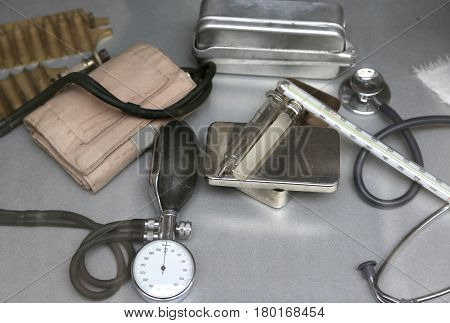 vintage medical Instruments with a measuring pressure and glass syringe