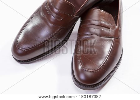 Footwear Concepts. Closeup of Pair of Stylish Brown Penny Loafer Shoes Against White Background. Horizontal Image Orientation