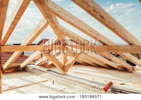 Installation Of Wooden Beams At House Construction Site. Building Details With Wood, Timber And Meta