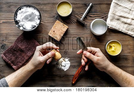 male hairdressing concept with barbershop hands and shaving tools set on wooden table background top view