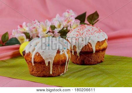 Easter cake with branches of willow on a pink table. Close-up
