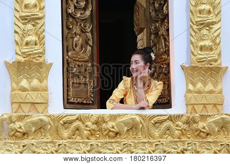 Beautiful laos woman on the Buddhist church Smiling she happiness in luang prabang laos