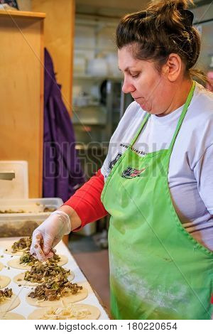 Woman Making Traditional Russian Piroshki At The Piroshki Piroshki Bakery At Pike Place Market In Se