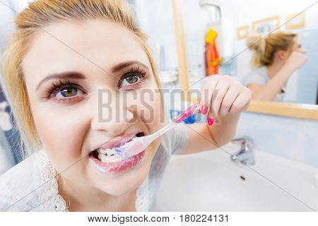 Woman Brushing Cleaning Teeth In Bathroom