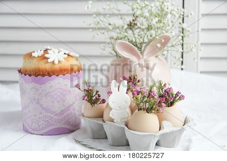 Easter cake in the form of the Easter Bunny and Easter decor with flowers on the table