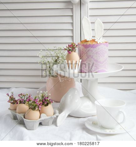 Easter cake in the form of the Easter Bunny and Easter decor with flowers on the table