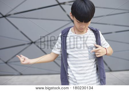 Portrait Of Cool Asian Kid Posing Outdoors