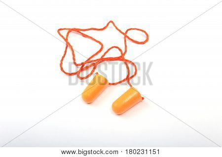 Orange earplug and safety glasses. Earplug to reduce noise on a white background