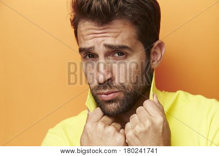 Posing guy in yellow portrait studio shot