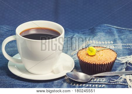 Hot Fresh Coffee In White Cup And Soft Cake On Blue Jeans On Table.coffee Break. Relax Times. Vintag