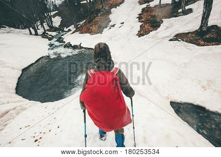 Traveler with backpack hiking snowy forest Travel Lifestyle concept adventure active vacations outdoor wild nature