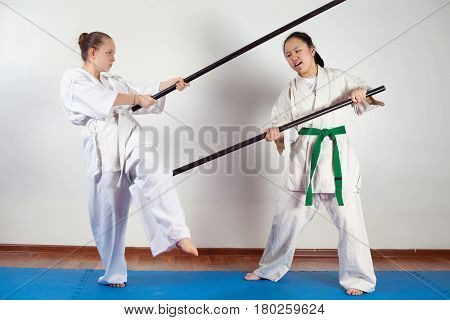 Two girls demonstrate martial arts working together. Fighting position active lifestyle practicing fighting techniques