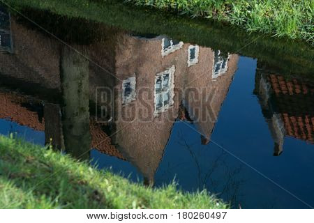 Walking along the small canal in old Dutch village Heusden sunny Sunday morning spring season.