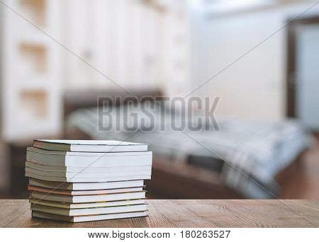 books on old wooden table in the bedroom