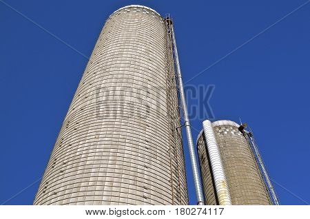 Two tall concrete state silos reach high into the sky