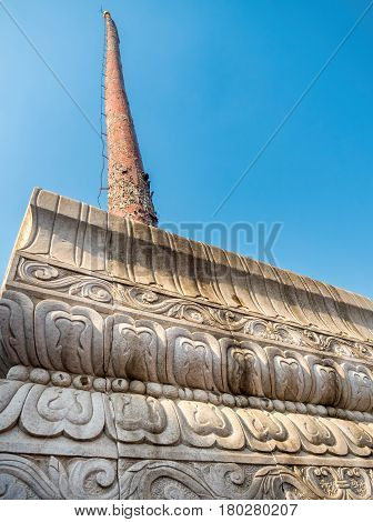 Tianjin, China - Nov 1, 2016: Long and aged pole on a solid ornate marble base along the famous Tianjin Ancient Cultural Street (Guwenhua Jie).
