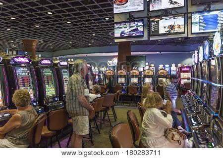 HALLANDALE BEACH USA - MAR 11 2017: People gambling at the slot machines at Gulfstream park casino in Hallandale Beach. Florida United States