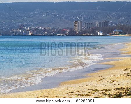 The sandy beach and city on a sunny day