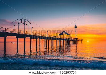 People walking along Brighton Jetty at sunset. South Australia