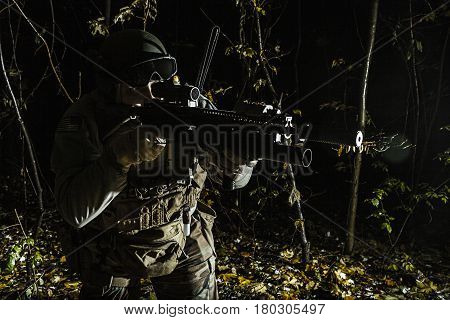 United states Marine Corps special operations command Marine Special Operator also known as Marsoc raider aiming weapons in the greenery at nighttime