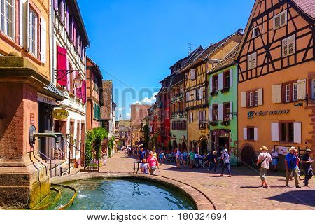 Riquewihr France-June 23 2016: Tourists are walking on the main shopping street; Rue du General de Gaulle in Riquewihr Alsace wine road