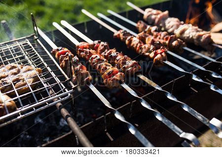 Closeup Of Some Meat Skewers Being Grilled In A Barbecue. Outdoors