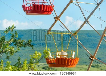 Scenic view of a colourful cabins of Ferris wheel on the natural background