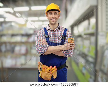 Electrician with tools on blurred background