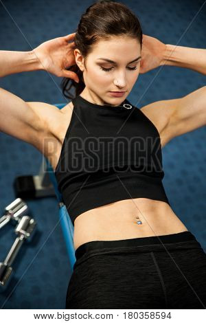 Attractive fit woamn working out abs in fitness gym making ab intervals